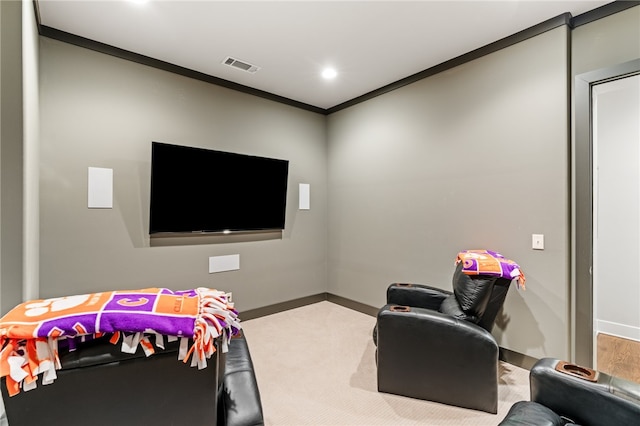 carpeted cinema room featuring crown molding