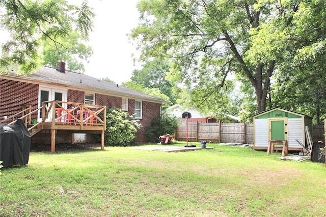 view of yard with a shed and a deck