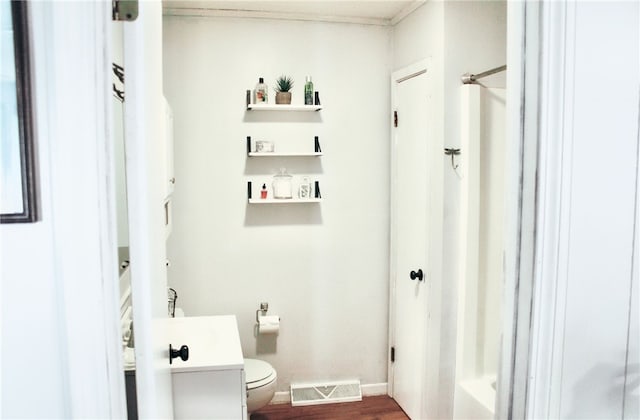 bathroom with toilet and hardwood / wood-style floors