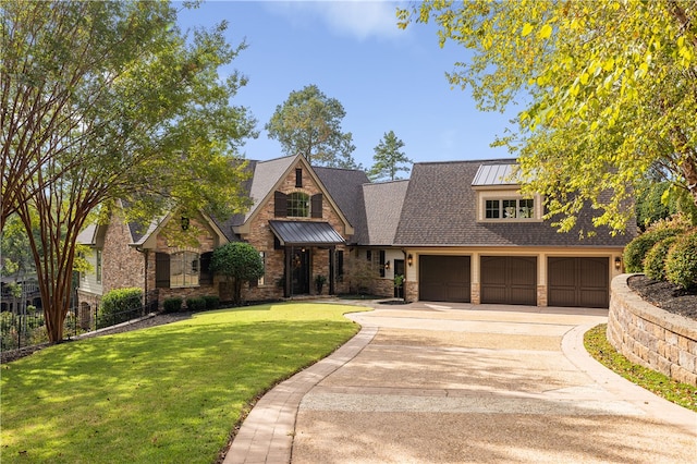 view of front of home with a front lawn and a garage