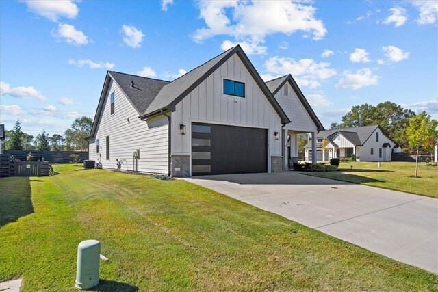 2 Winding Rock Rd, Simpsonville, SC 29680 - view of property exterior with board and batten siding, a garage, a yard, concrete driveway, and stone siding