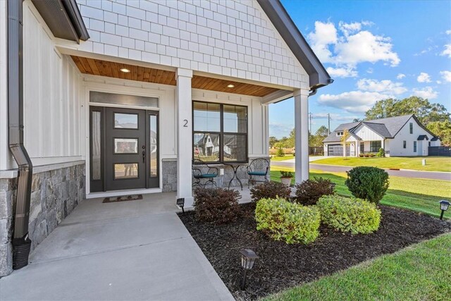2 Winding Rock Rd, Simpsonville, SC 29680 - view of exterior entry featuring covered porch, a yard, and stone siding