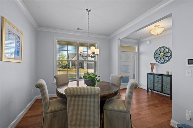 2 Winding Rock Rd, Simpsonville, SC 29680 - dining area featuring a chandelier, wood finished floors, crown molding, and baseboards