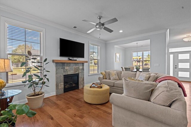 2 Winding Rock Rd, Simpsonville, SC 29680 - living room with crown molding, wood finished floors, ceiling fan, a glass covered fireplace, and baseboards