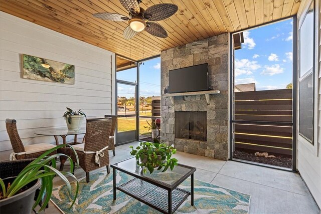 2 Winding Rock Rd, Simpsonville, SC 29680 - living room featuring expansive windows, a ceiling fan, wooden ceiling, an outdoor stone fireplace, and wood walls