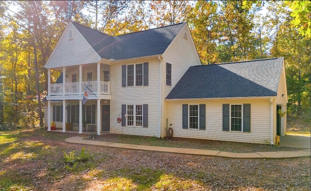 rear view of property with a balcony and a patio