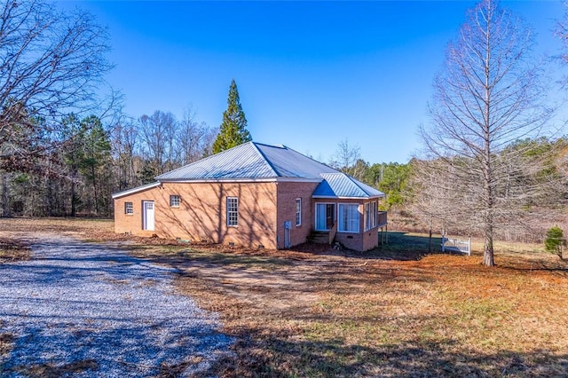 view of property exterior with a sunroom