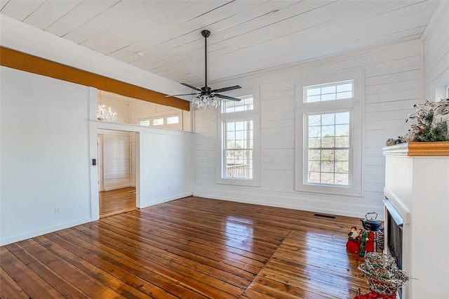 unfurnished living room featuring ceiling fan and dark hardwood / wood-style flooring