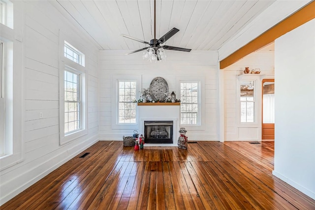 unfurnished living room with hardwood / wood-style floors, wooden ceiling, ceiling fan, and lofted ceiling