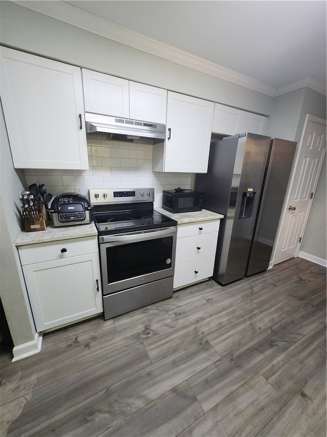 kitchen featuring tasteful backsplash and white cabinetry