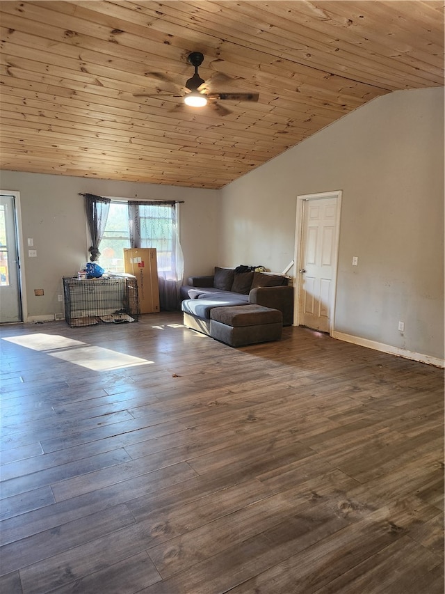 interior space with hardwood / wood-style floors, multiple windows, lofted ceiling, and wood walls