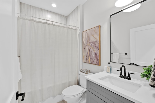 full bathroom featuring vanity, toilet, and shower / tub combo