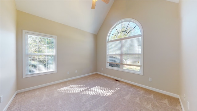 carpeted empty room featuring lofted ceiling and ceiling fan