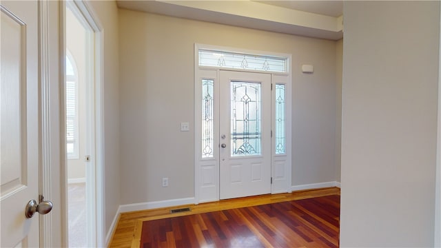 foyer featuring plenty of natural light and dark hardwood / wood-style floors