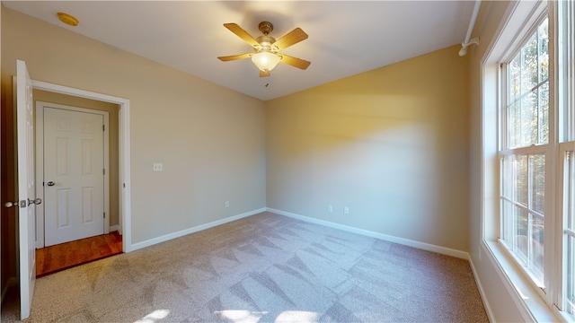 carpeted empty room with ceiling fan