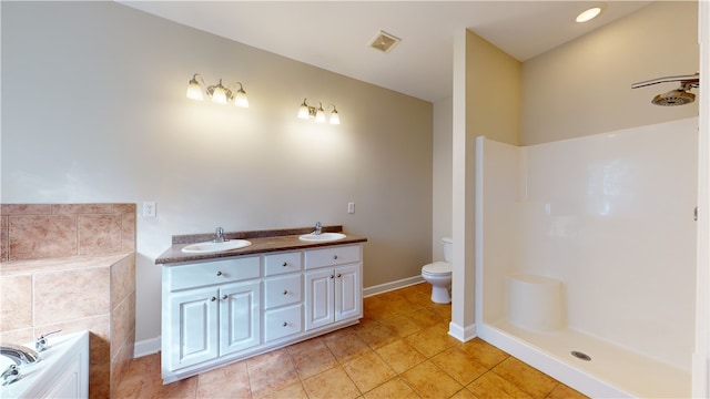 bathroom with vanity, tile patterned floors, a bathtub, and toilet