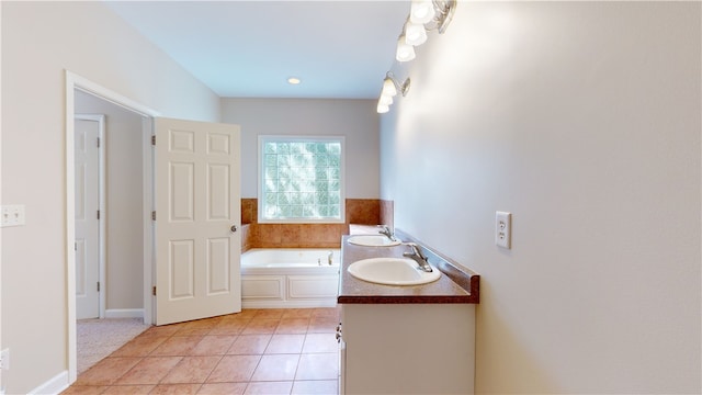 bathroom with tile patterned floors, vanity, and a bath