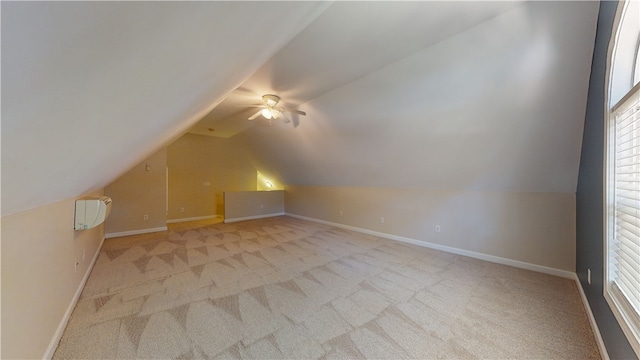 bonus room with ceiling fan, vaulted ceiling, and light carpet