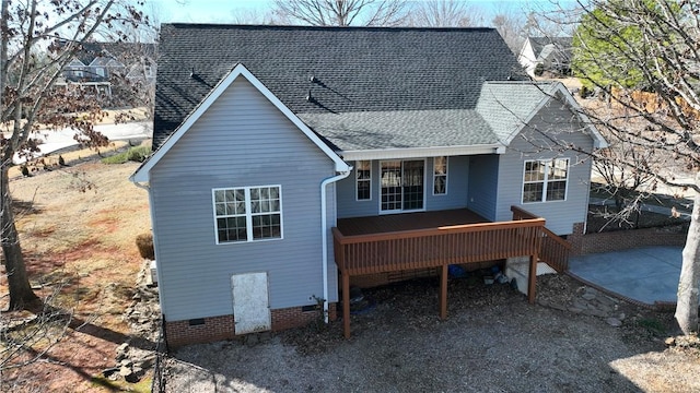 rear view of property featuring a wooden deck