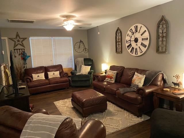 living room featuring ceiling fan and wood-type flooring