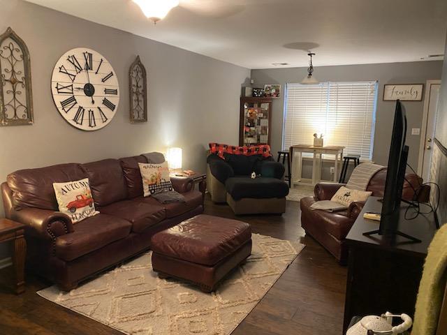 living room with dark hardwood / wood-style flooring