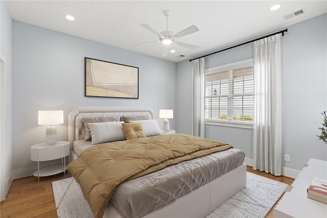 bedroom featuring visible vents, baseboards, recessed lighting, a ceiling fan, and light wood-style flooring