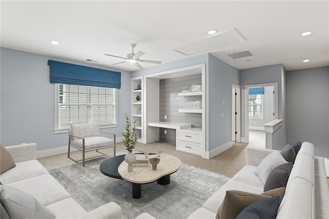 living room featuring light colored carpet and ceiling fan