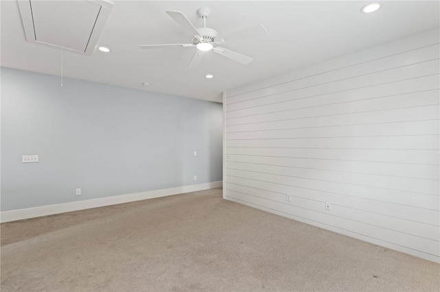 spare room with baseboards, attic access, recessed lighting, and light colored carpet