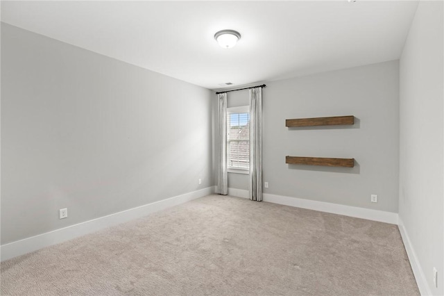 unfurnished room featuring baseboards and carpet flooring