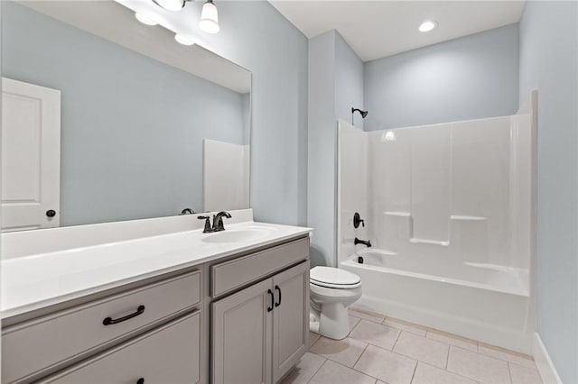 bathroom featuring tile patterned flooring, tub / shower combination, toilet, and vanity