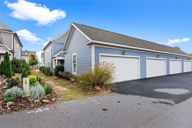 view of side of home with a garage