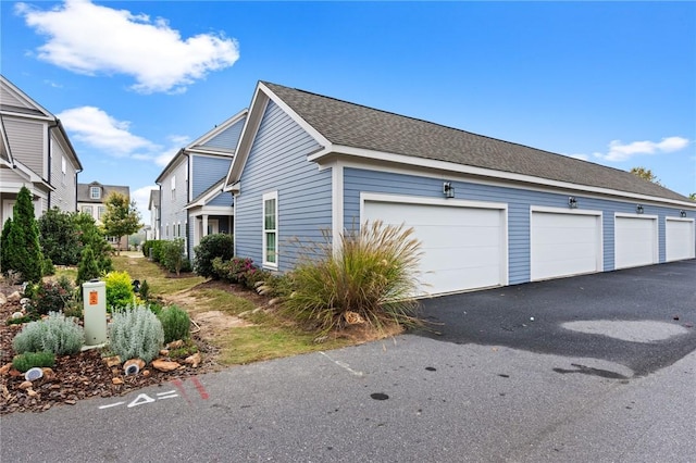 view of home's exterior featuring community garages