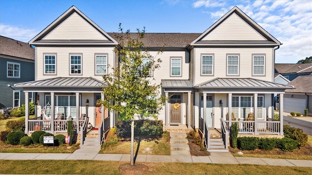 view of front of property featuring covered porch and a garage