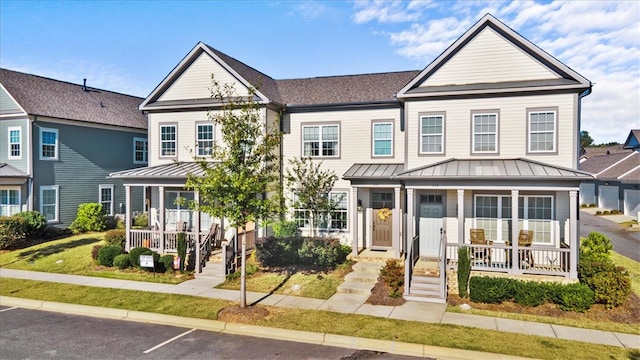 view of front of house with a porch and a front lawn