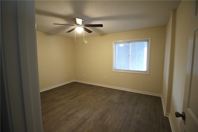 unfurnished room with a textured ceiling, ceiling fan, and dark hardwood / wood-style flooring