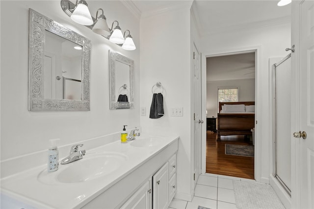 bathroom with vanity, tile patterned flooring, ornamental molding, and an enclosed shower