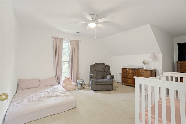 bedroom featuring light carpet, vaulted ceiling, and ceiling fan