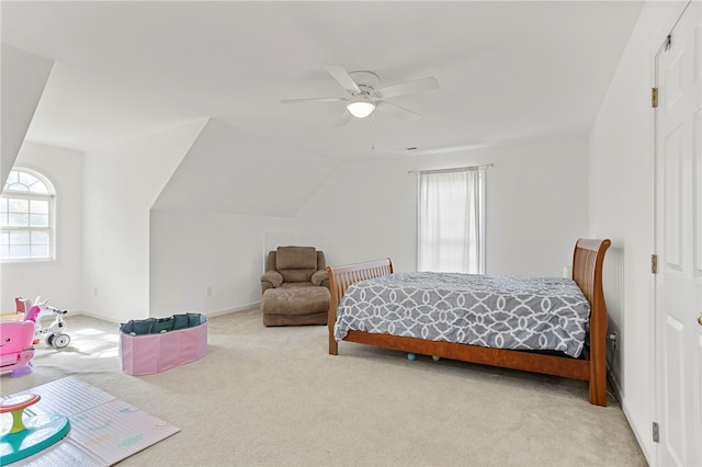 bedroom with lofted ceiling, light colored carpet, and ceiling fan