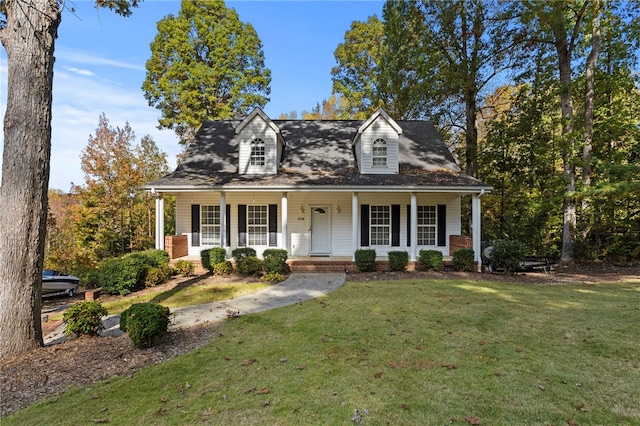 cape cod house featuring a porch and a front lawn