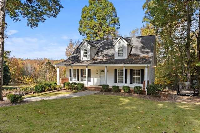 cape cod home featuring a front yard and a porch