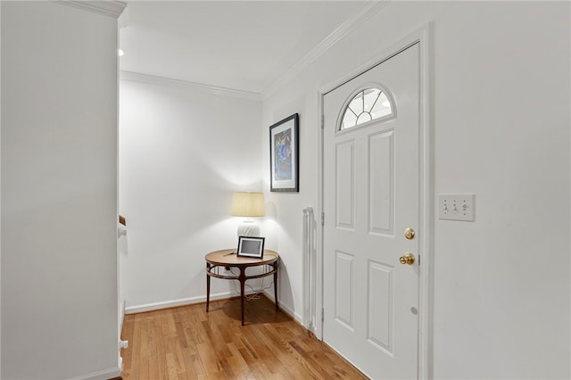 entrance foyer featuring ornamental molding and light hardwood / wood-style floors