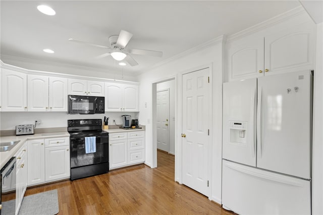 kitchen with light hardwood / wood-style flooring, black appliances, crown molding, white cabinetry, and ceiling fan