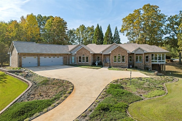 ranch-style home featuring a garage and a front yard