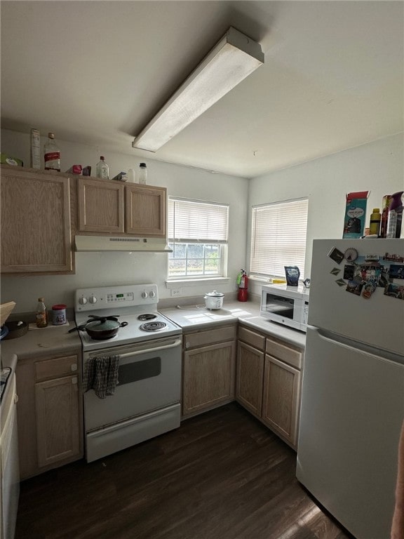 kitchen featuring white appliances, dark wood-type flooring, and light brown cabinets