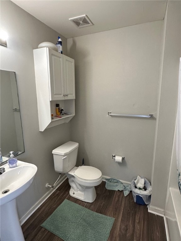 bathroom featuring toilet and hardwood / wood-style floors