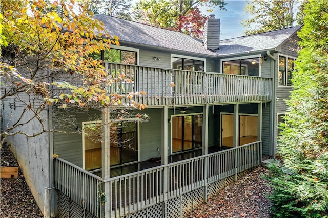 back of property with a sunroom