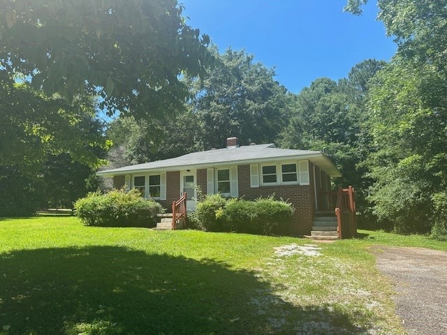 ranch-style house with a front lawn