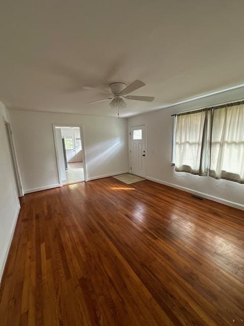 interior space with dark hardwood / wood-style floors and ceiling fan