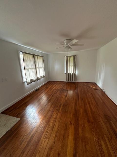 spare room featuring ceiling fan and dark hardwood / wood-style flooring