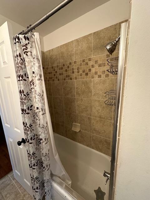 bathroom featuring shower / bathtub combination with curtain